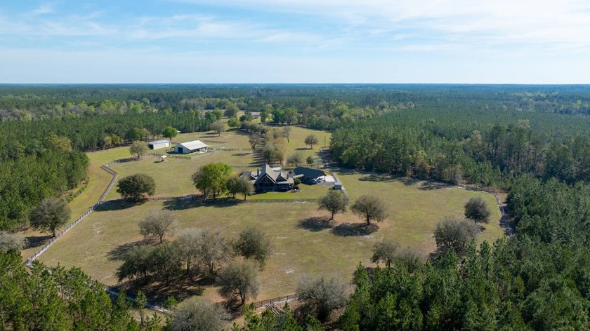 This riverfront property features an expansive, custom log home - photo 48