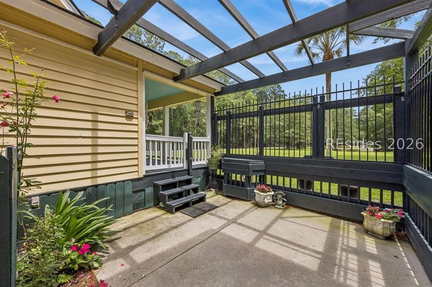 Tucked behind wrought iron gates on over four private, fenced - photo 36