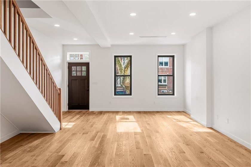 This fully renovated three-story, two-family brick townhouse in - photo 4