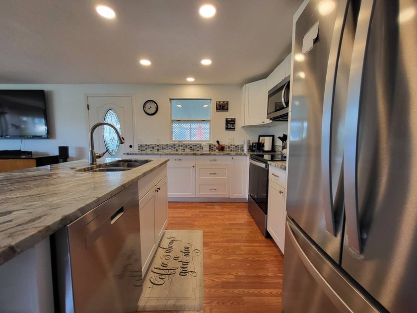 BEAUTIFUL RENOVATION IS TURNKEY AND INCLUDES GOLF CART! Just - photo 22