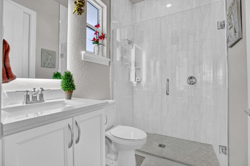 This stunning corner-lot home offers breathtaking lake views and - photo 18