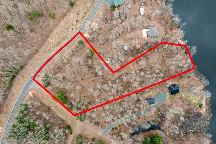 Experience a premier 2.9-acre wooded waterfront lot on Clam - photo 2