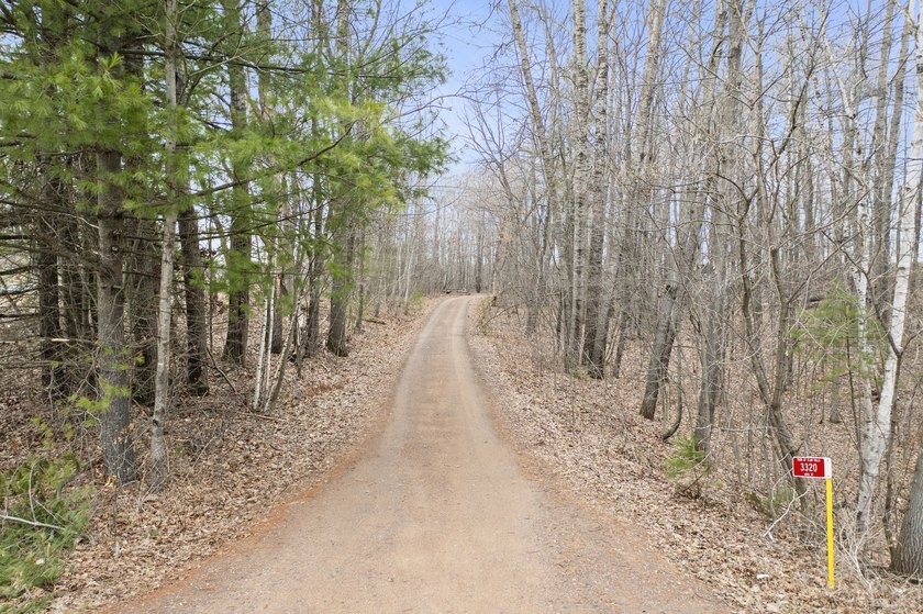 Experience a premier 2.9-acre wooded waterfront lot on Clam - photo 8