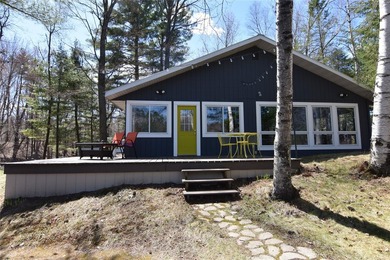 Nestled among mature pines and hardwoods, this adorable cabin - photo 2