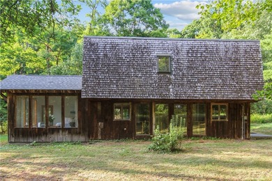Beautiful contemporary home tucked into the woods with a creek