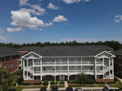 Enjoy effortless coastal living in this first floor, end-unit