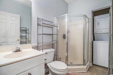 Enjoy effortless coastal living in this first floor, end-unit