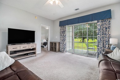 Enjoy effortless coastal living in this first floor, end-unit