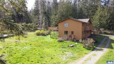 Nestled on 5 private acres in Sequim, this stunning 3 - photo 2
