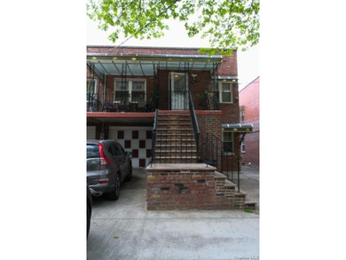 Welcome to this well-maintained two-family brick home located in - photo 1
