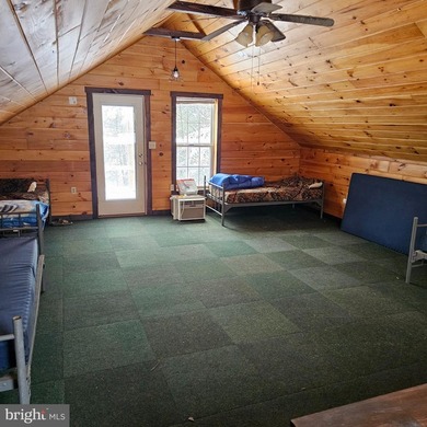 Recreational use wood frame cabin with detached garage and pond - photo 7
