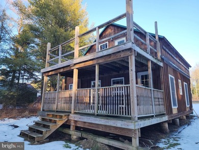 Recreational use wood frame cabin with detached garage and pond - photo 10