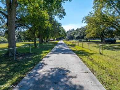Set on 27 wooded acres in Lafayette, LA, this rare private - photo 2