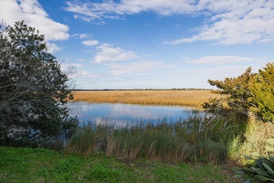 Welcome to this beautifully maintained Marsh Winds end-unit