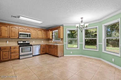A welcoming three-bedroom, two-bath vinyl-sided home combines - photo 11