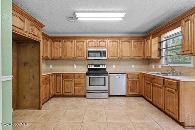 A welcoming three-bedroom, two-bath vinyl-sided home combines - photo 12