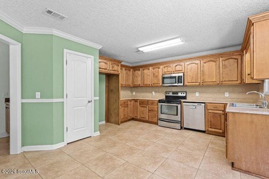 A welcoming three-bedroom, two-bath vinyl-sided home combines - photo 15