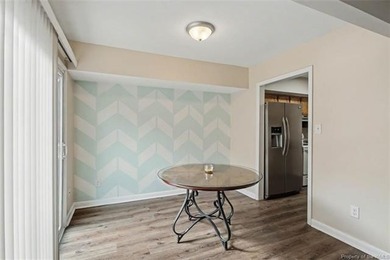 Freshly painted, newer LVP floors downstairs, newer carpet - photo 5