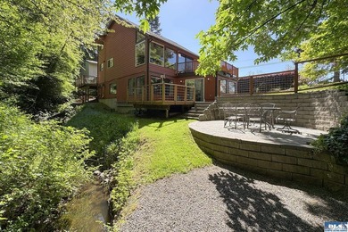 Tucked into a peaceful, creekside setting, this 3-bedroom - photo 1