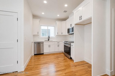 An exceptional new construction 6/6 two-family home offering 2 - photo 7