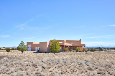 24 Hunter Drive is a pueblo style home in the Vista de Pedernal