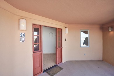 24 Hunter Drive is a pueblo style home in the Vista de Pedernal