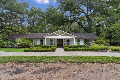 Tucked away on nearly a full acre on St. Simons Island, this - photo 1
