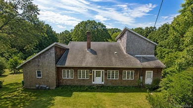 Set on a private 1.18-acre property in Hampton Bays, this - photo 2