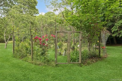 Set on a private 1.18-acre property in Hampton Bays, this - photo 7