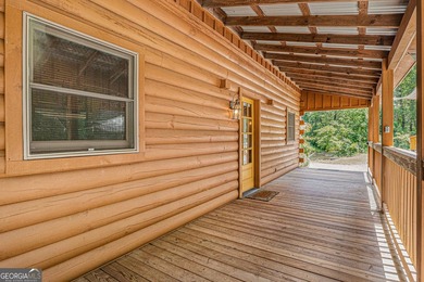 This beautiful log cabin home is located on the edge of the - photo 4