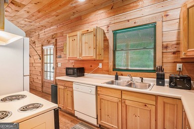 This beautiful log cabin home is located on the edge of the - photo 10