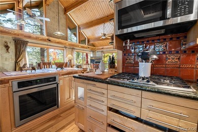 Perched among the trees in sought-after Moonridge, this - photo 7