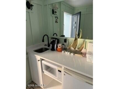 Discover the charm of Pier Village in this beautifully located - photo 6