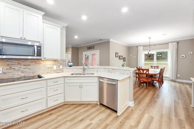 Welcome to this stunning, custom-built 2020 brick home in a