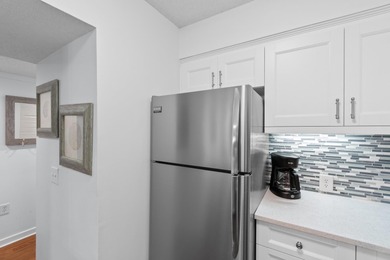 This move-in ready, updated two-bedroom, two-bath condo features