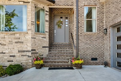 Constructed with a brick and stone exterior and highlighted by - photo 3