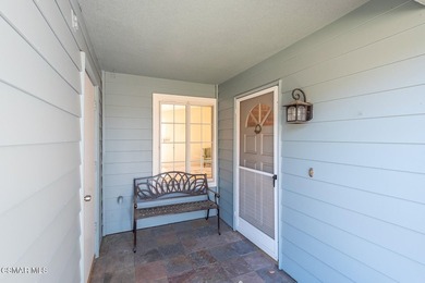 Highly desirable Cape Cod single story end unit! This charming