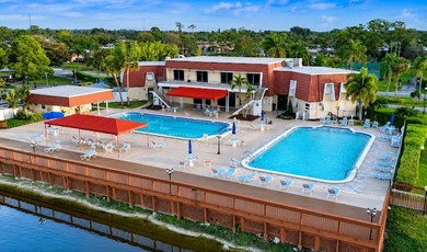 Welcome to this desirable 55+ community End-unit villa in the - photo 16