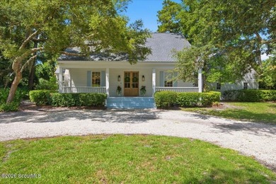 Nestled beneath a canopy of majestic live oaks in one of St - photo 1