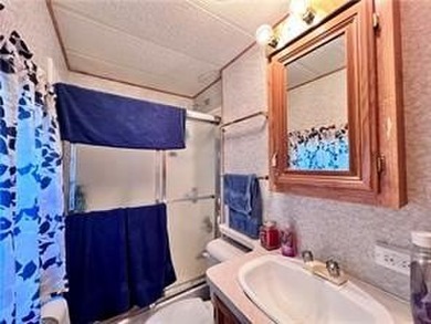 Introducing a charming property nestled on the serene shores of - photo 12