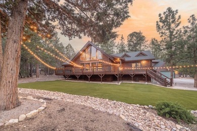 Nestled among the pines on a beautifully wooded acre, this - photo 3