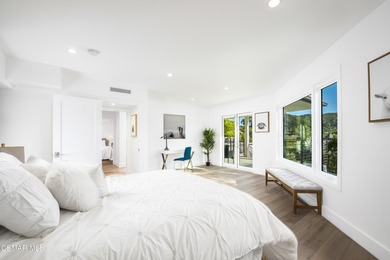 A modern residence defined by glass, light, and landscape. - photo 8