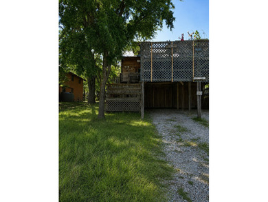 The property features a charming two-story log cabin that - photo 3