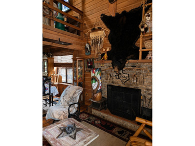 The property features a charming two-story log cabin that - photo 6