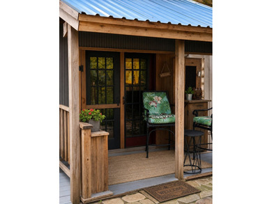 The property features a charming two-story log cabin that - photo 10