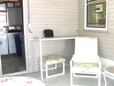 LARGE GREEN SPACE FACING THE WATER FROM A LARGE FLORIDA ROOM - photo 17