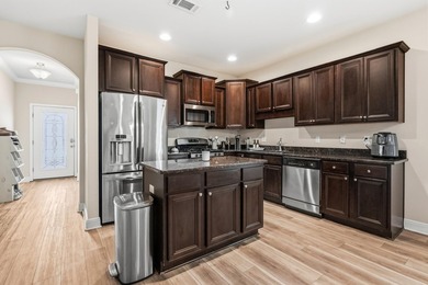 Newer LVP flooring flows through this open-concept Hammock Bay - photo 8