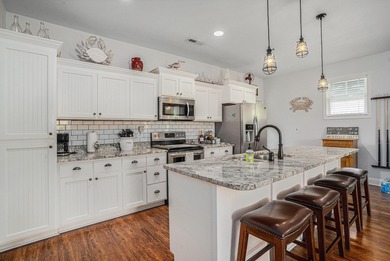 Inlet Living at Its Best! Welcome to this charming raised beach