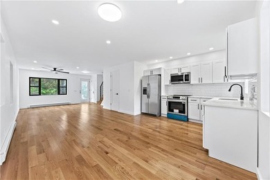 Welcome to this completely renovated two-family home in the - photo 3