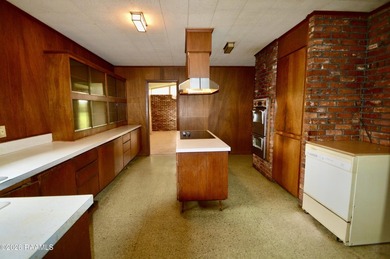 Welcome to a rare bayou-front opportunity offering privacy